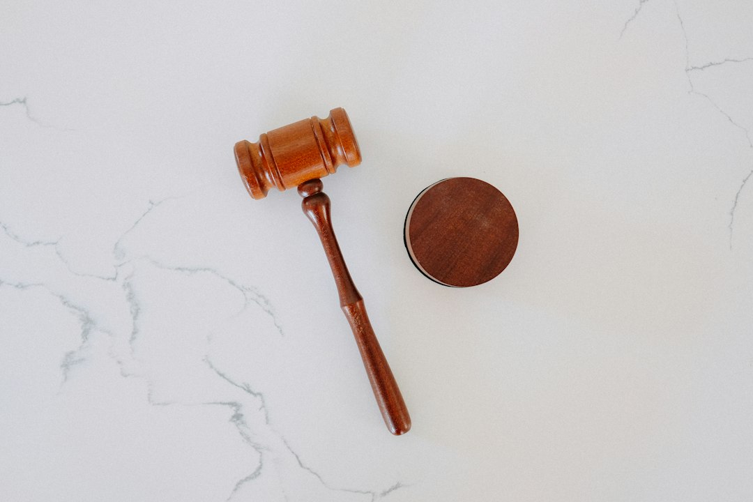 A wooden gavel on a white marble surface