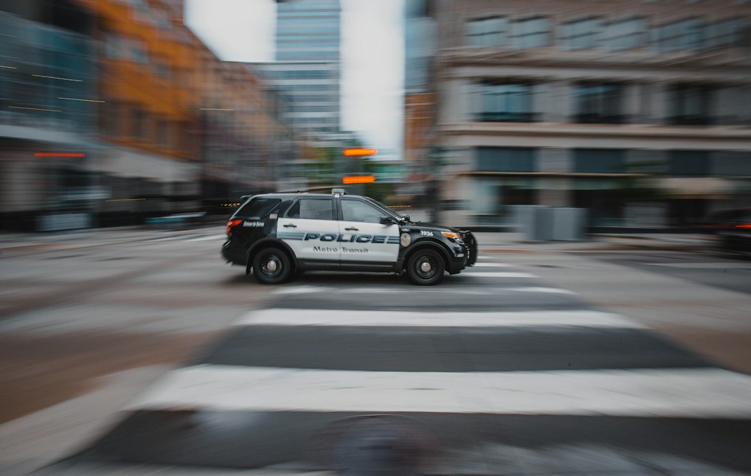 A black and white police car on a city street
